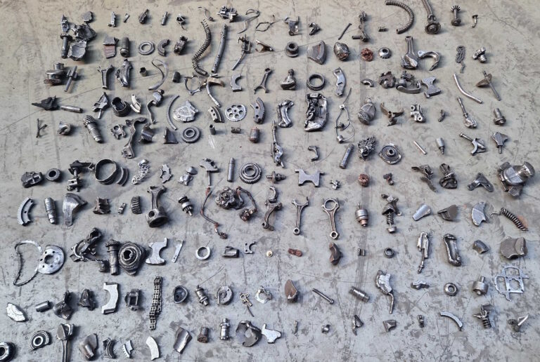 Hand-sorted metal scrap samples arranged on the floor before sensor data acquisition.