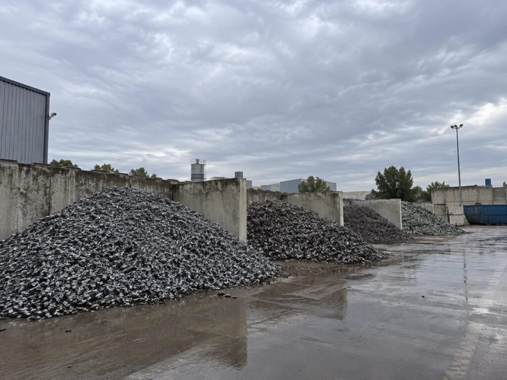 Separated fractions stored as heaps in concrete bunker bays at a recycling plant